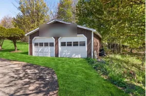 Before: a two-car garage with white roll-up doors
